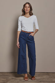 Model Madeline wearing size 10 of The Reversible Cotton Stretch Top in colour White (White), from the front, showing the whole outfit