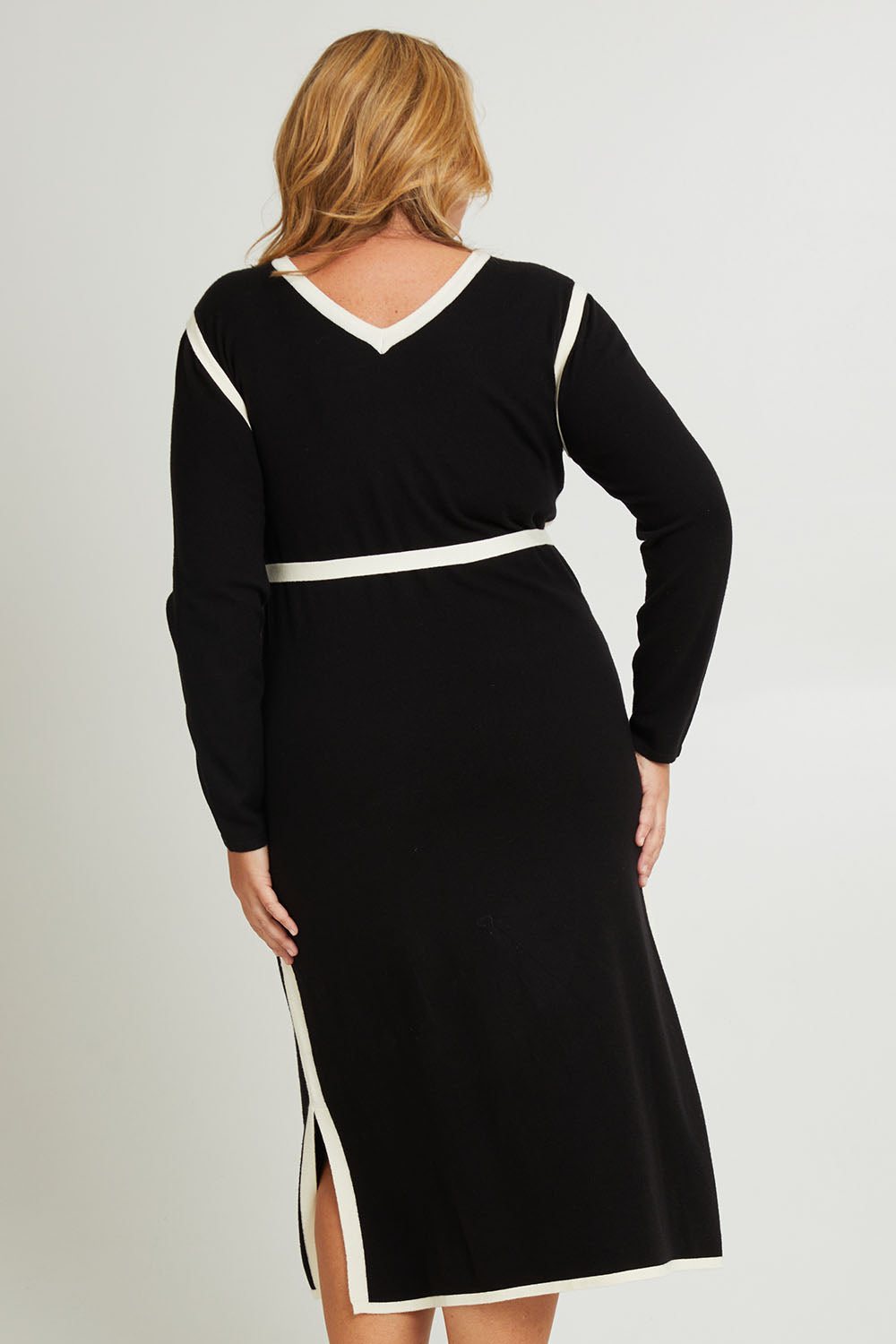 Model Fiona wearing size XL of The Reversible Contrast Detail Knit Dress in colour Black (Black), from the back