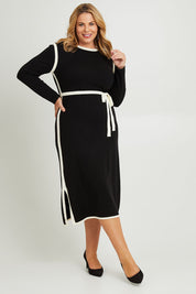 Model Fiona wearing size XL of The Reversible Contrast Detail Knit Dress in colour Black (Black), from the front, showing the whole outfit