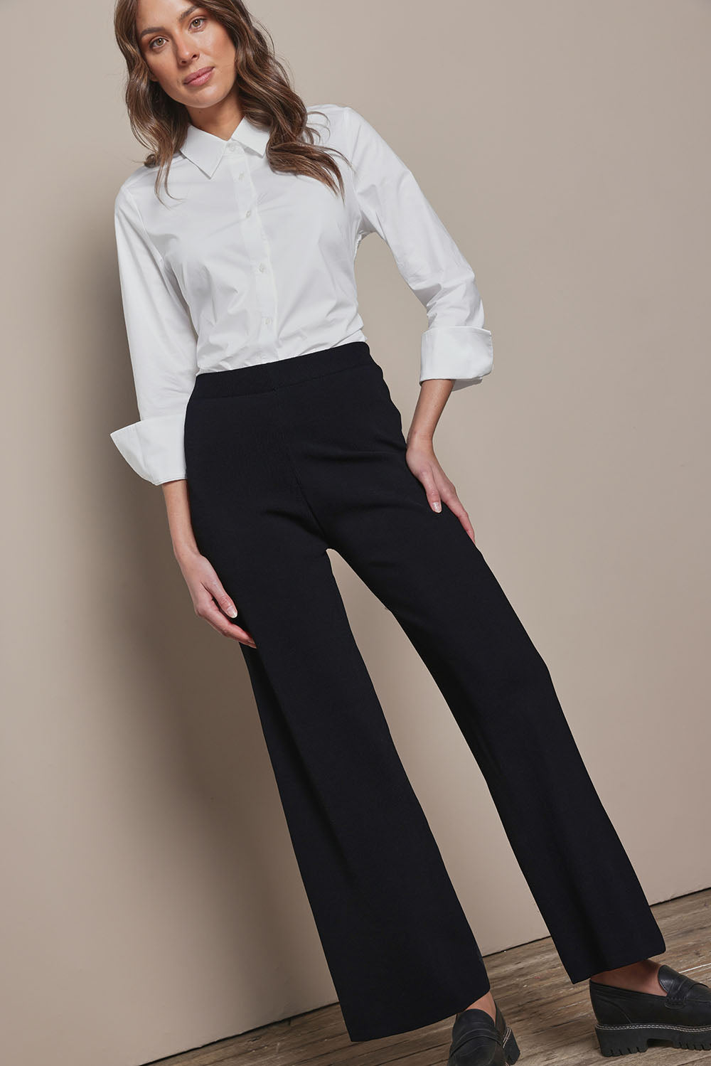 Model Madeline wearing size 10 of The Classic Cotton Stretch Shirt in colour White (White), from the front, showing the whole outfit