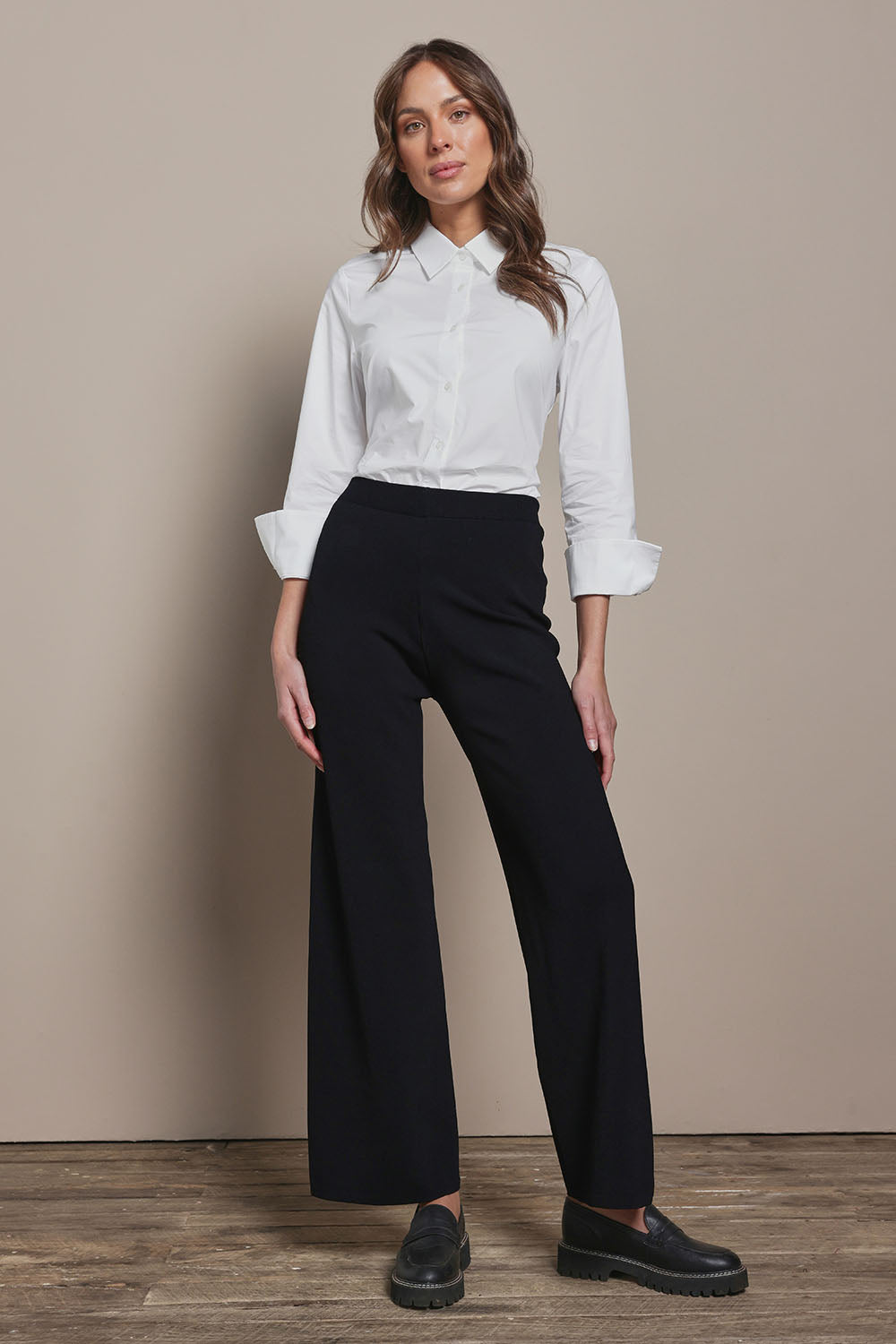 Model Madeline wearing size 10 of The Classic Cotton Stretch Shirt in colour White (White), from the front, showing the whole outfit