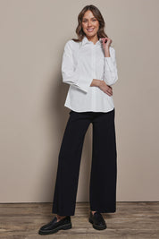 Model Madeline wearing size 10 of The Classic Cotton Stretch Shirt in colour White (White), from the front, showing the whole outfit