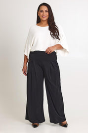 Model Ashleigh wearing size 16 of The Palazzo Jersey Pull On Pant in colour Black (Black), from the front, showing the whole outfit