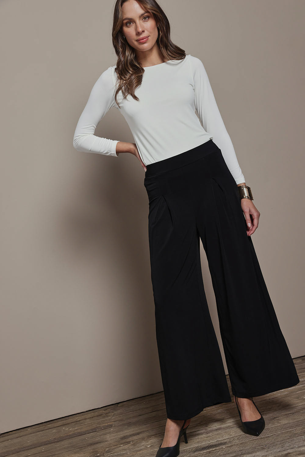 Model Madeline wearing size 10 of The Palazzo Jersey Pull On Pant in colour Black (Black), from the front, showing the whole outfit