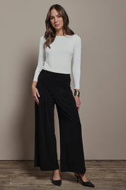 Model Madeline wearing size 10 of The Palazzo Jersey Pull On Pant in colour Black (Black), from the front, showing the whole outfit