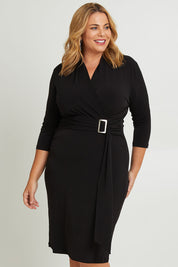 Model Fiona wearing size 16 of The Elegant Buckle Dress in colour Black (Black), from the front, cropped image