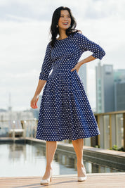 Model Miranda wearing size 10 of The 3/4 Sleeve Cotton Stretch Dress in colour Spots (Blue), from the front, showing the whole outfit