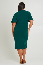 Model Ashleigh wearing size 16 of The Mock Wrap Dress in colour Pine (Green), from the back
