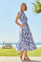 Model Riina wearing size 10 of The Shirred Waist Button Through Dress in colour Tropics (Blue), from the front, showing the whole outfit