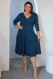 Model Stacey wearing size L of The 3/4 Sleeve Reversible Knit Dress in colour Darkpetrol (Blue), from the front, showing the whole outfit