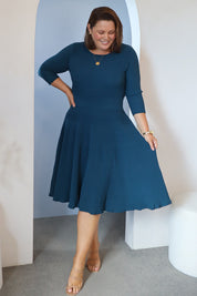 Model Stacey wearing size L of The 3/4 Sleeve Reversible Knit Dress in colour Darkpetrol (Blue), from the front, showing the whole outfit