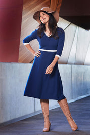 Model Miranda wearing size S of The Fit And Flare Knit Dress in colour NavyIvory (Blue), from the front, showing the whole outfit