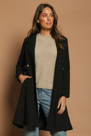 Model Madeline wearing size 10 of The Tab Detail Tailored Longline Coat in colour Black (Black), from the front, cropped image