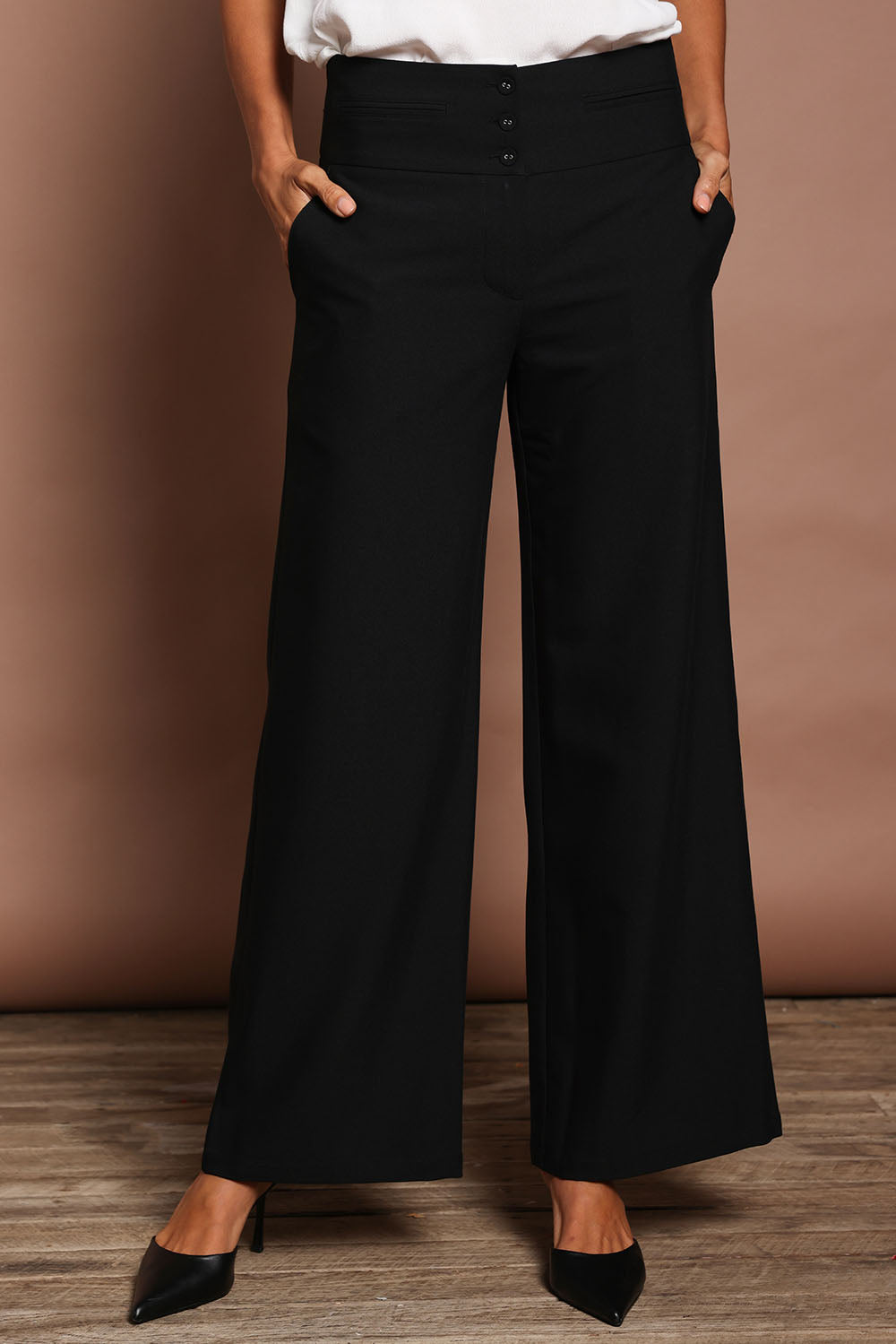Model Amanda wearing size 10 of The Tailored Pant in colour Black (Black), from the front, cropped image