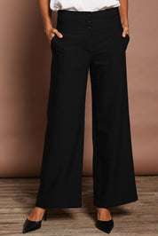Model Amanda wearing size 10 of The Tailored Pant in colour Black (Black), from the front, cropped image