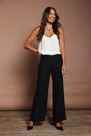 Model Amanda wearing size 10 of The Tailored Pant in colour Black (Black), from the front, showing the whole outfit
