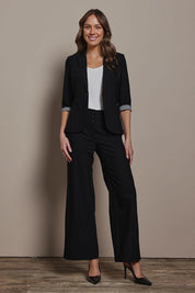 Model Madeline wearing size 10 of The Tailored Pant in colour Black (Black), from the front, showing the whole outfit