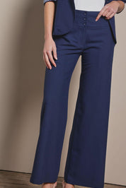 Model Madeline wearing size 10 of The Tailored Pant in colour Navy (Blue), from the front, cropped image
