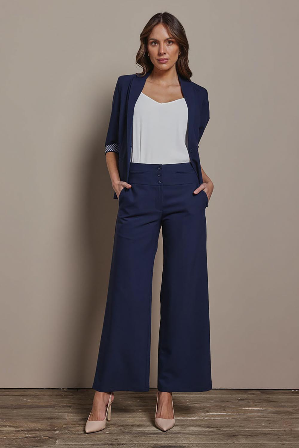 Model Madeline wearing size 10 of The Tailored Pant in colour Navy (Blue), from the front, showing the whole outfit