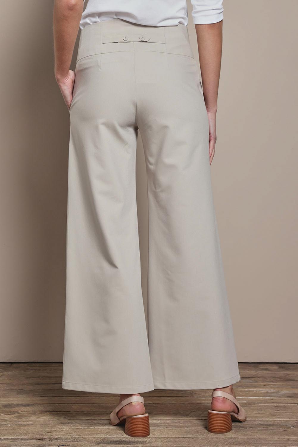 Model Madeline wearing size 10 of The Tailored Pant in colour Pebble, from the back