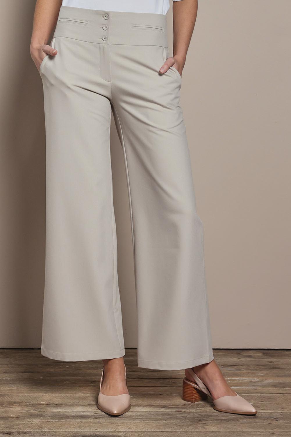 Model Madeline wearing size 10 of The Tailored Pant in colour Pebble, from the front, cropped image