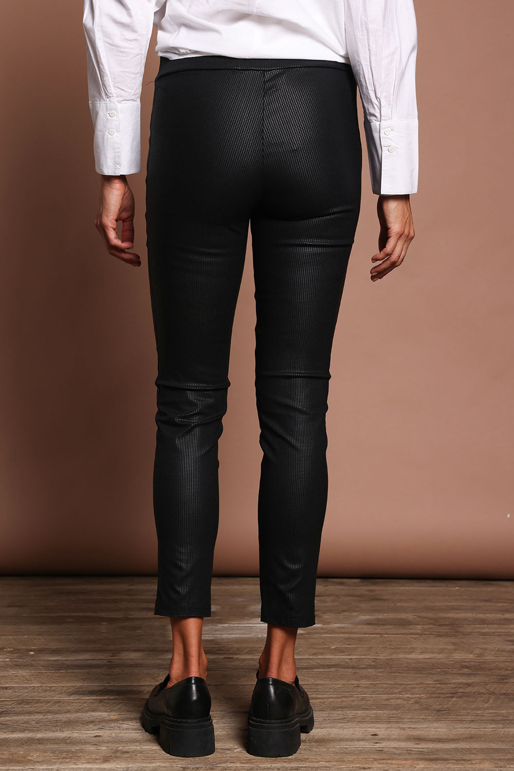Model Amanda wearing size 10 of The Define 7/8 Pull On Pant in colour Meteorite (Black), from the back