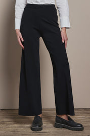 Model Madeline wearing size S of The Milano Knit Pull On Pant in colour Black (Black), from the front, cropped image