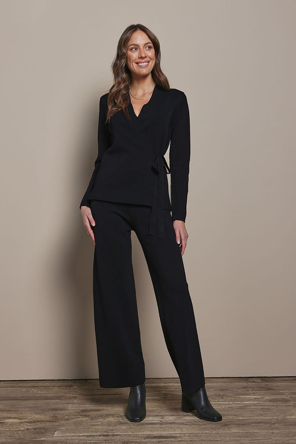 Model Madeline wearing size S of The Milano Knit Pull On Pant in colour Black (Black), from the front, showing the whole outfit