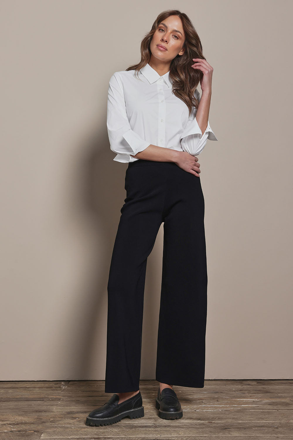 Model Madeline wearing size S of The Milano Knit Pull On Pant in colour Black (Black), from the front, showing the whole outfit