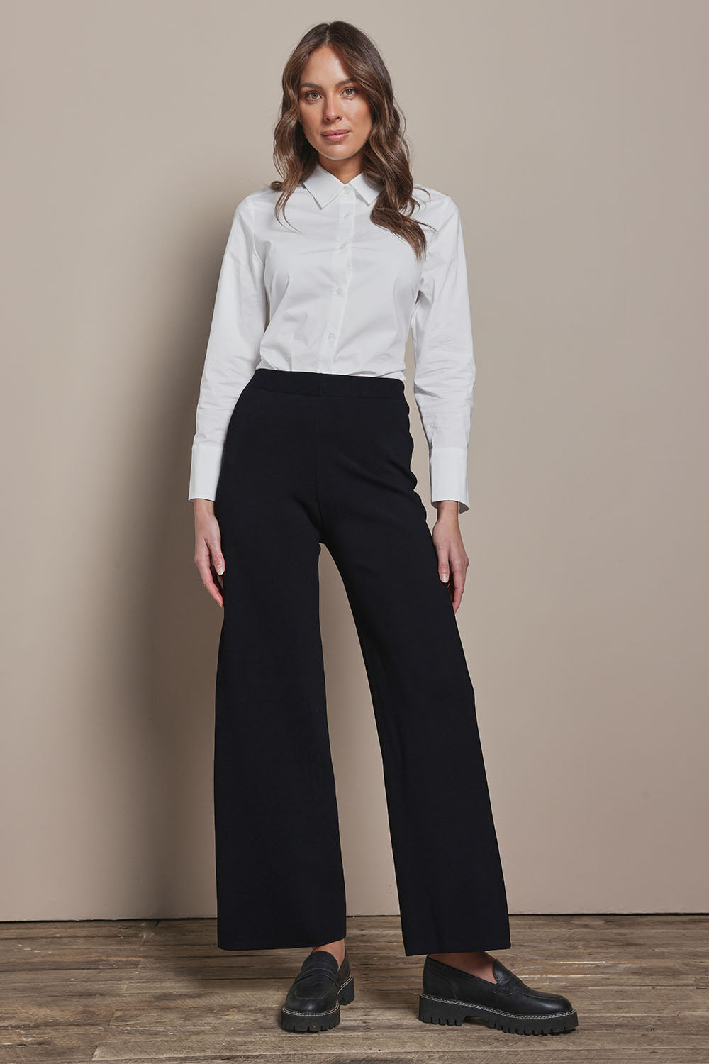 Model Madeline wearing size S of The Milano Knit Pull On Pant in colour Black (Black), from the front, showing the whole outfit