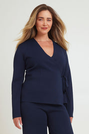 Model Chanel wearing size XL of The Milano Knit Wrap Top in colour Darknavy (Blue), from the front, cropped image