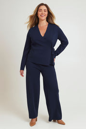 Model Chanel wearing size XL of The Milano Knit Wrap Top in colour Darknavy (Blue), from the front, showing the whole outfit