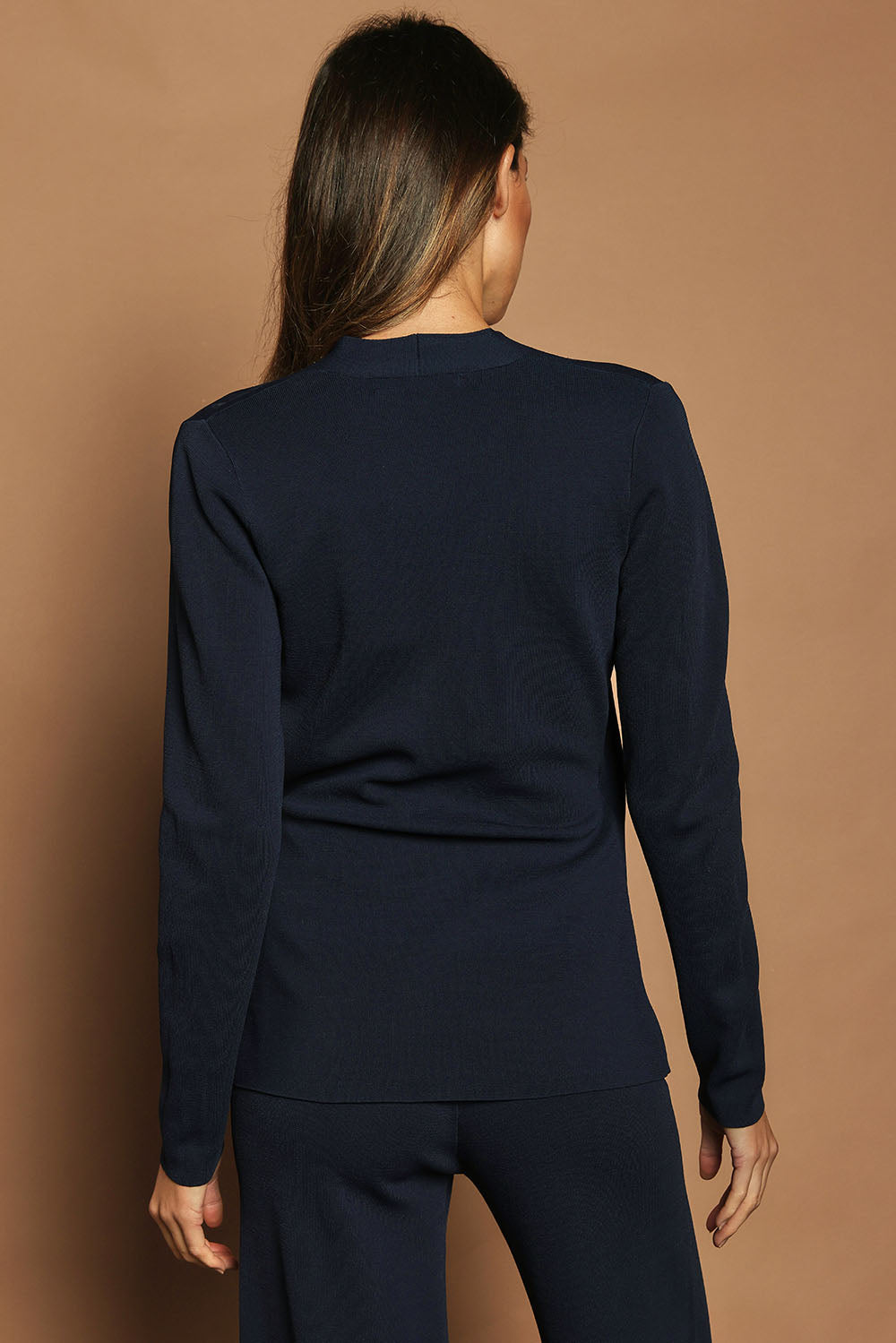 Model Madeline wearing size S of The Milano Knit Wrap Top in colour Darknavy (Blue), from the back