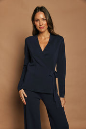 Model Madeline wearing size S of The Milano Knit Wrap Top in colour Darknavy (Blue), from the front, showing the whole outfit