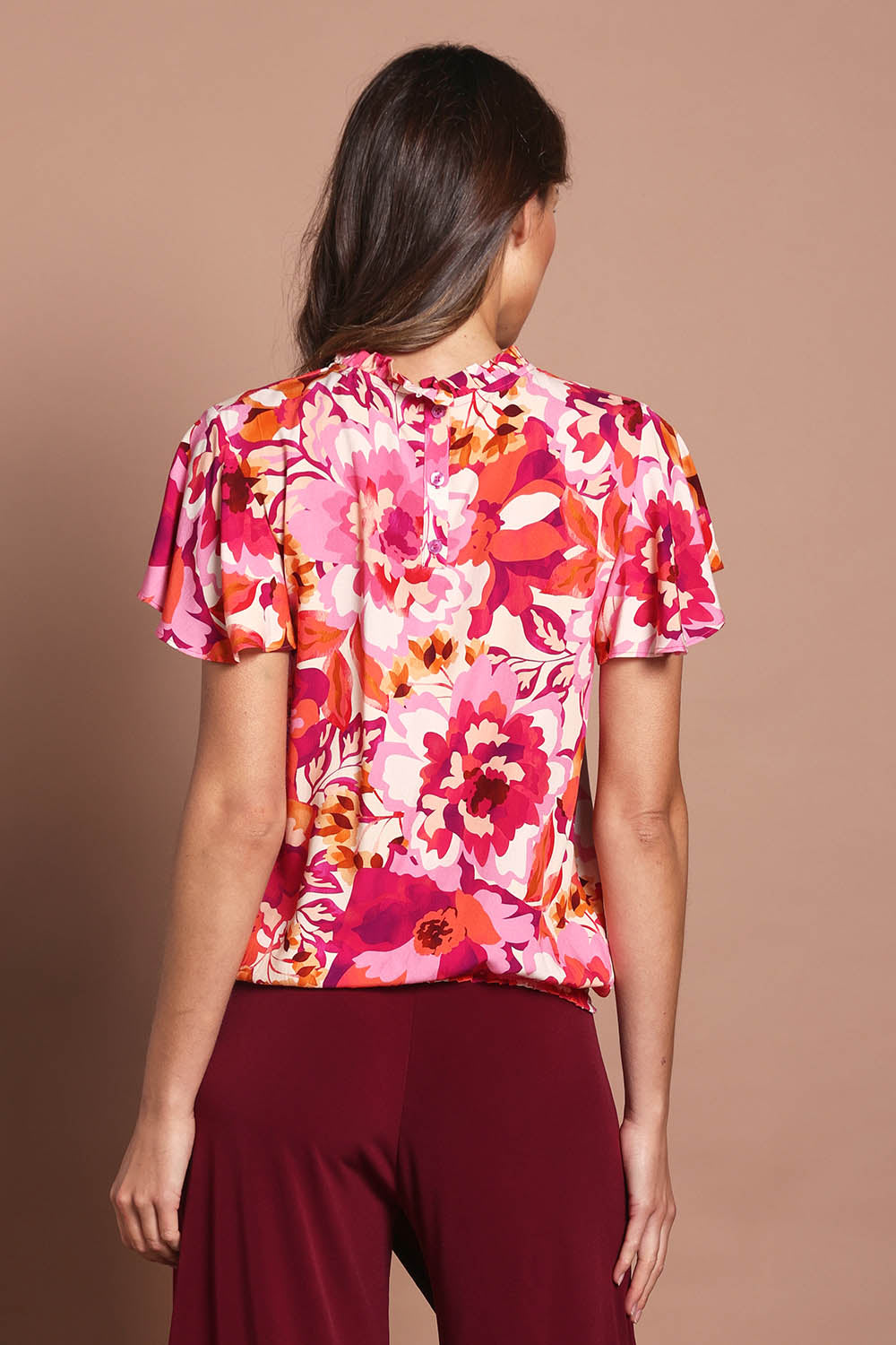 Model Madeline wearing size 10 of The Shirring Detail Printed Top in colour Blooms (Pink), from the back