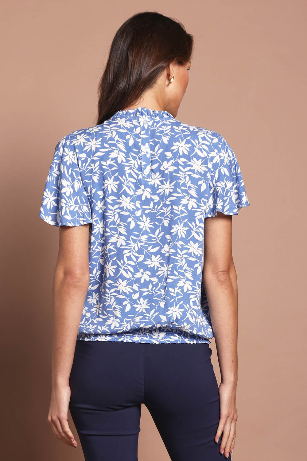 Model Madeline wearing size 10 of The Shirring Detail Printed Top in colour Bluefleur (Blue), from the back