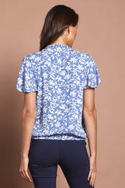 Model Madeline wearing size 10 of The Shirring Detail Printed Top in colour Bluefleur (Blue), from the back