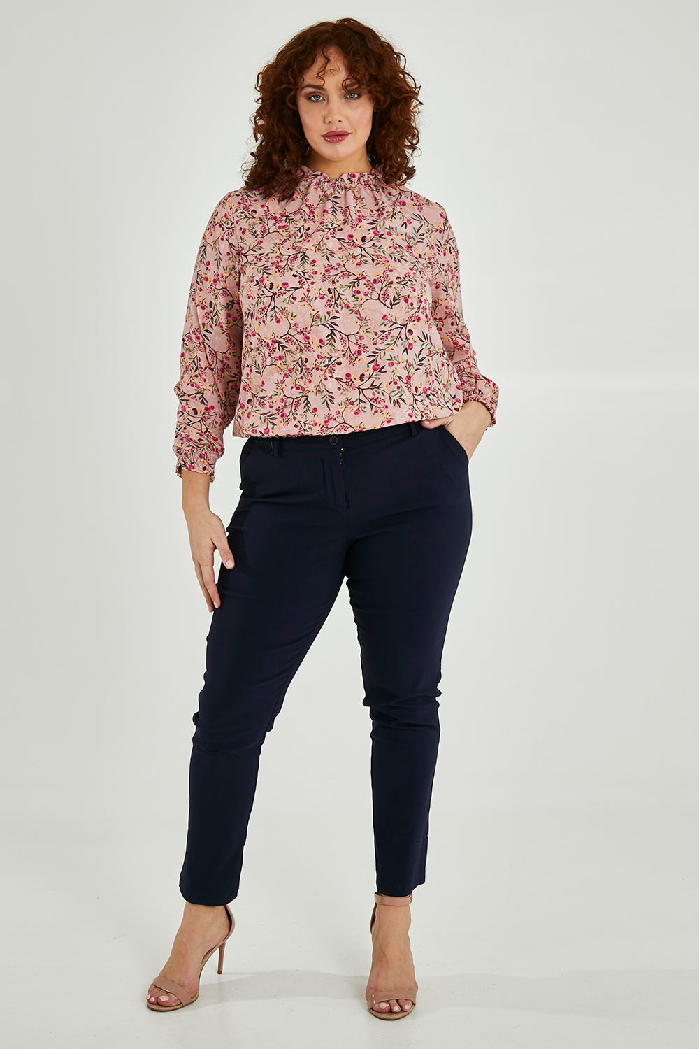 Model Maddy wearing size 16 of The Shirring Detail Printed Blouse in colour Blossom (Pink), from the front, showing the whole outfit
