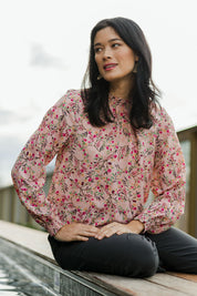 Model Miranda wearing size 10 of The Shirring Detail Printed Blouse in colour Blossom (Pink), from the front, showing the whole outfit