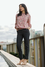 Model Miranda wearing size 10 of The Shirring Detail Printed Blouse in colour Blossom (Pink), from the front, showing the whole outfit