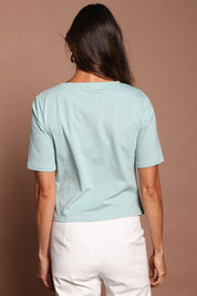 Model Amanda wearing size 10 of The Cotton Stretch Waist Detail Top in colour Duckegg (Blue), from the back
