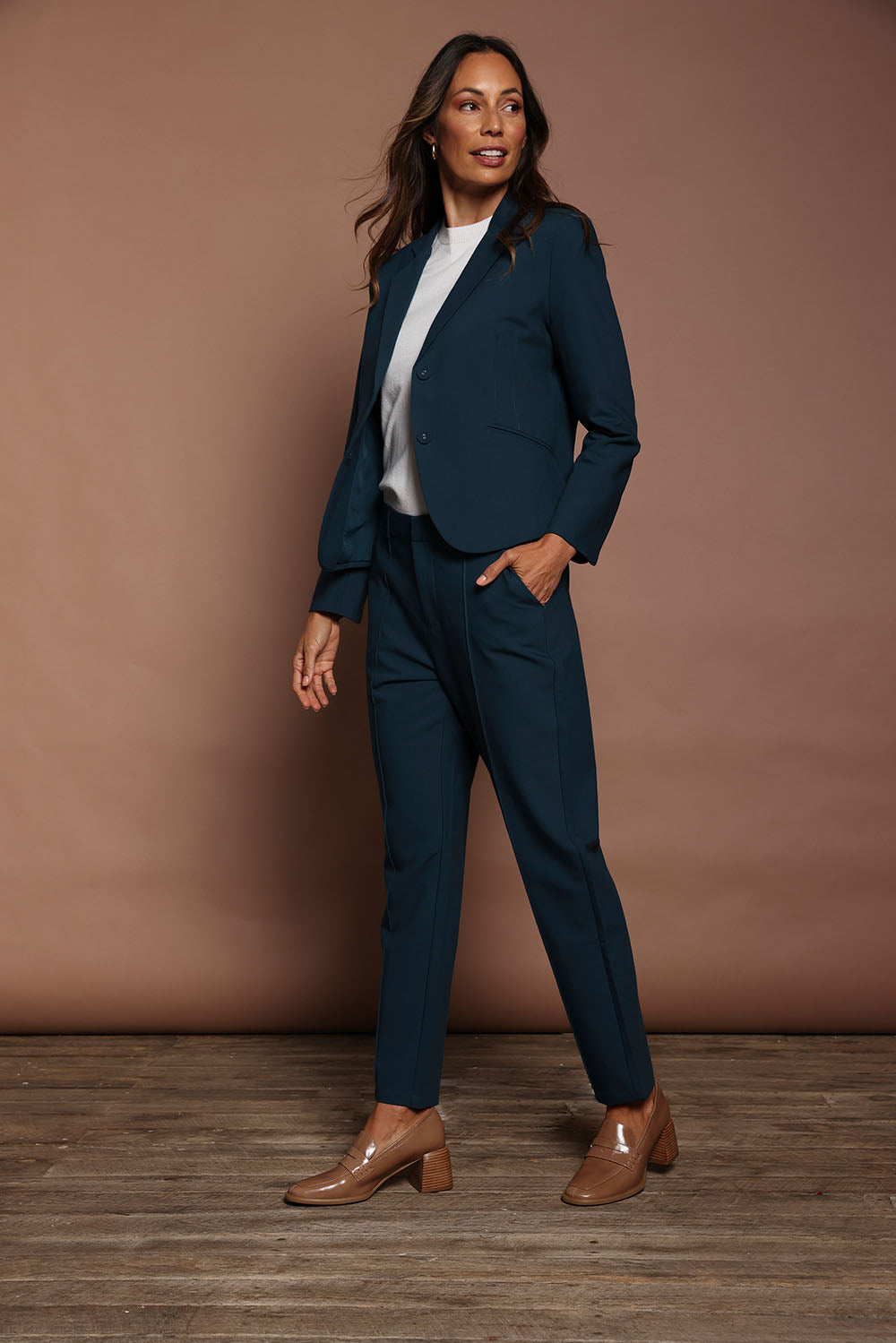 Model Amanda wearing size 10 of The Pintuck Detail Tailored Pant in colour Deepocean (Blue), from the front, showing the whole outfit