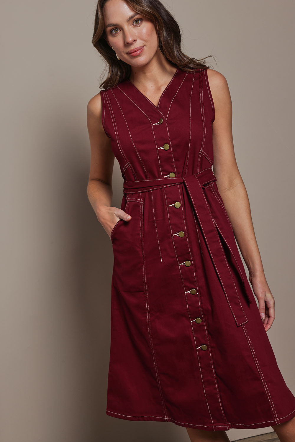 Model Madeline wearing size 10 of The Cotton Twill Contrast Stitching Dress in colour Burgundy (Red), from the front, cropped image