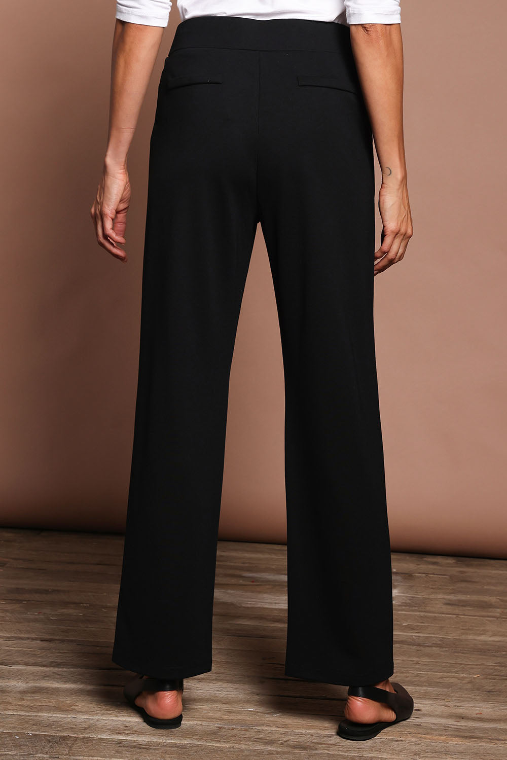 Model Amanda wearing size 10 of The Straight Cut Pull On Ponte Pant in colour Black (Black), from the back