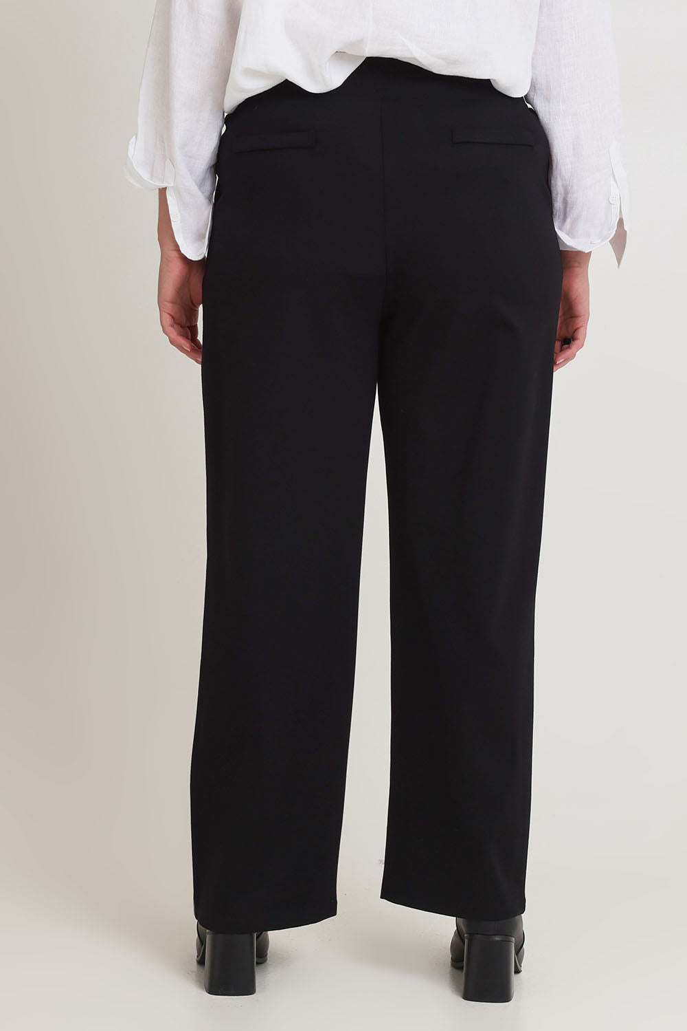 Model Chanel wearing size 16 of The Straight Cut Pull On Ponte Pant in colour Black (Black), from the back