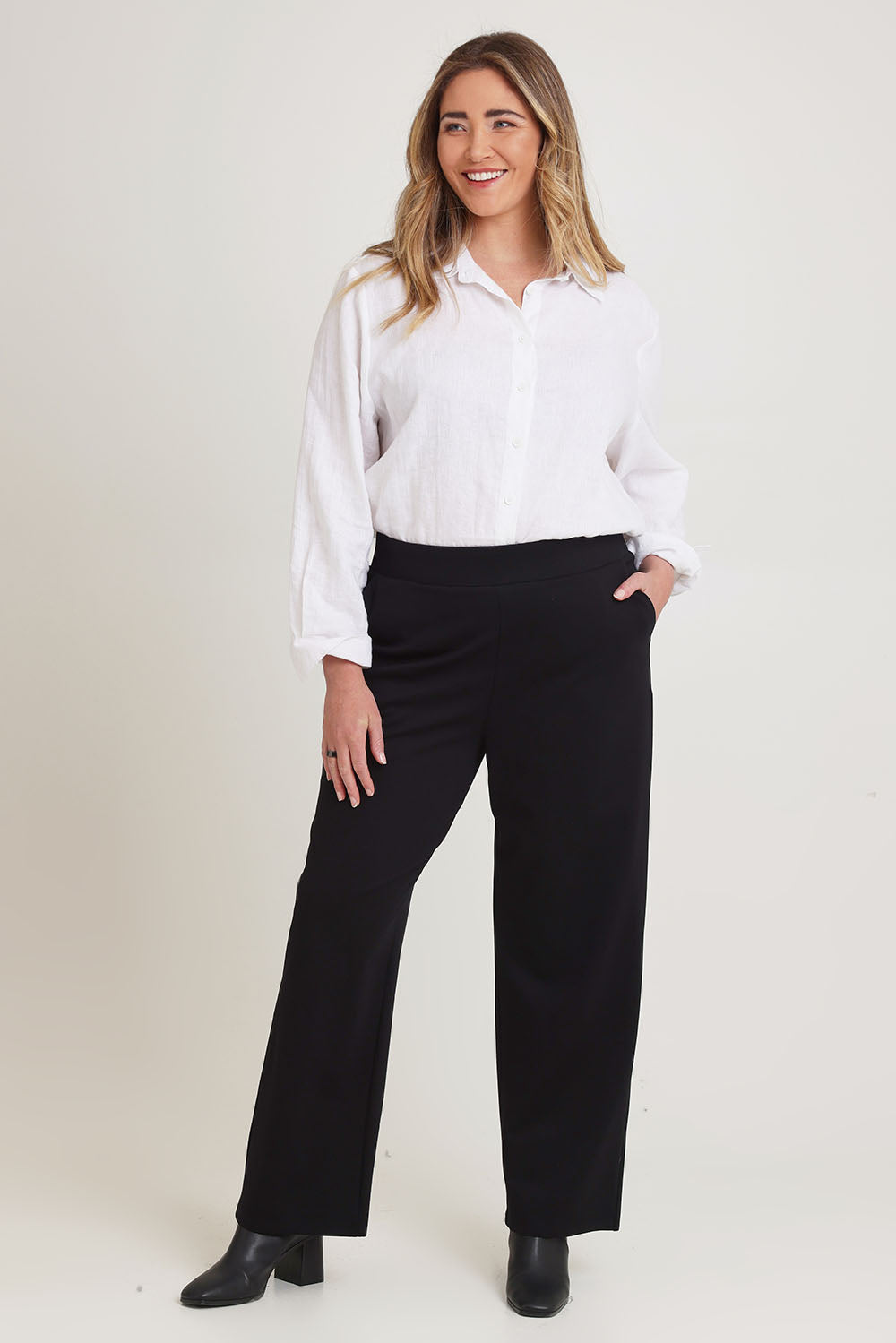 Model Chanel wearing size 16 of The Straight Cut Pull On Ponte Pant in colour Black (Black), from the front, showing the whole outfit