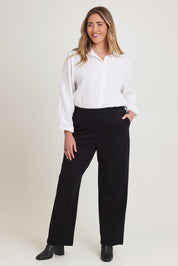 Model Chanel wearing size 16 of The Straight Cut Pull On Ponte Pant in colour Black (Black), from the front, showing the whole outfit