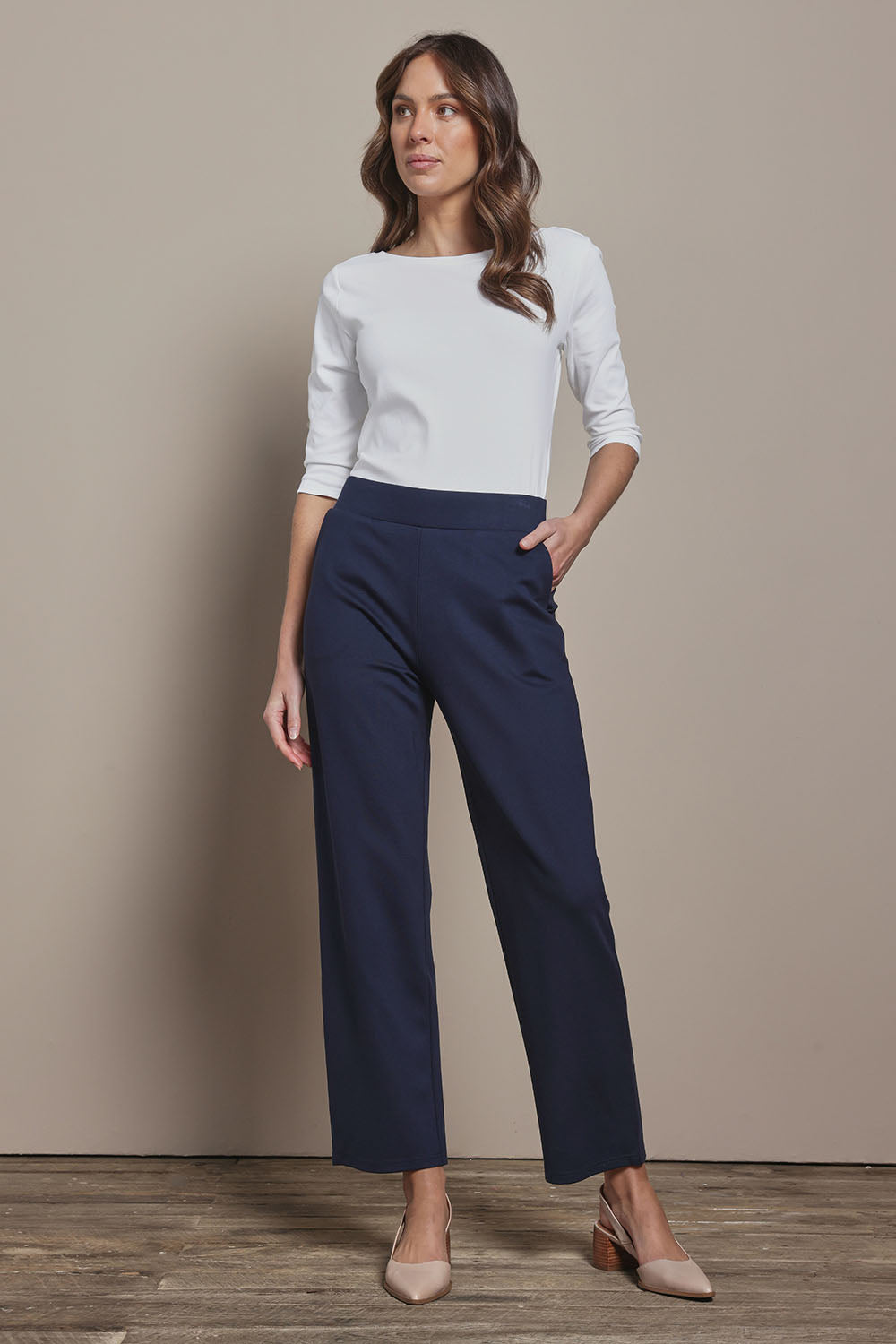 Model Madeline wearing size 10 of The Straight Cut Pull On Ponte Pant in colour Darknavy (Blue), from the front, showing the whole outfit