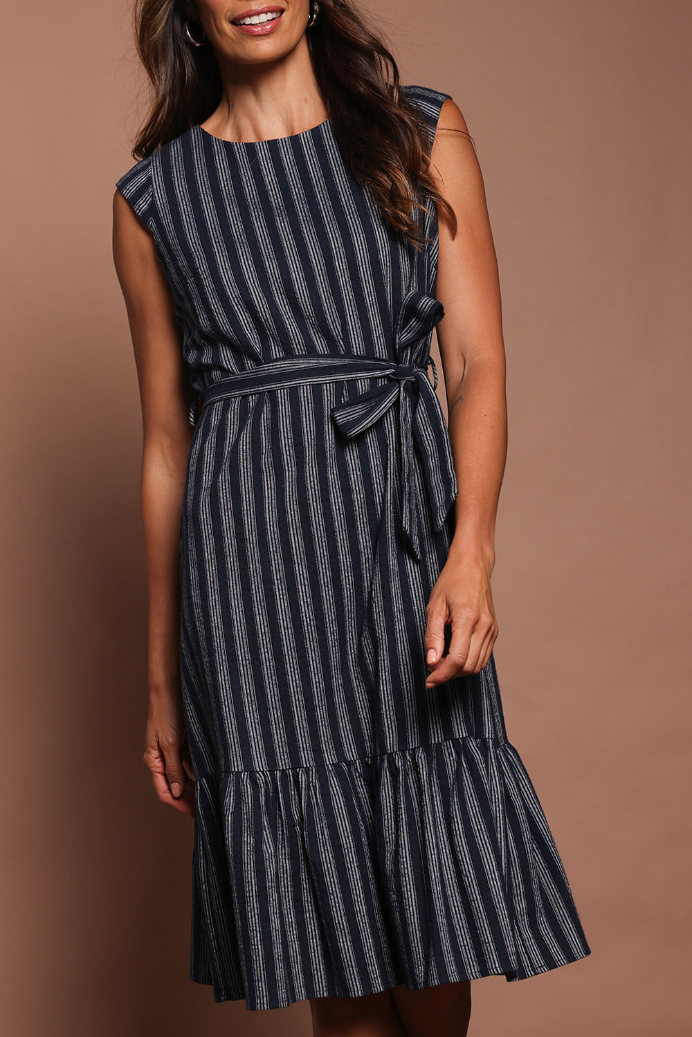 Model Amanda wearing size 10 of The Stripe Cotton Cap Sleeve Dress in colour Navy (Blue), from the front, cropped image