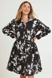 Model Chanel wearing size 16 of The Printed Cotton Stretch Shirt Dress in colour Blackfleur (Black), from the front, cropped image
